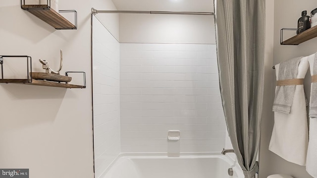 bathroom with shower / bath combination with curtain