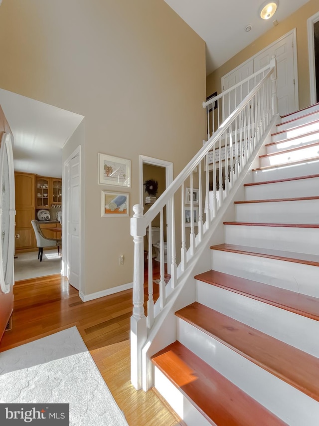 stairway with hardwood / wood-style floors