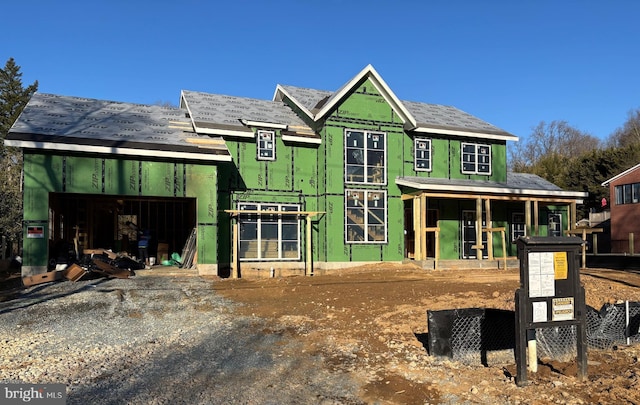 view of front of home featuring a garage, driveway, and an outdoor structure