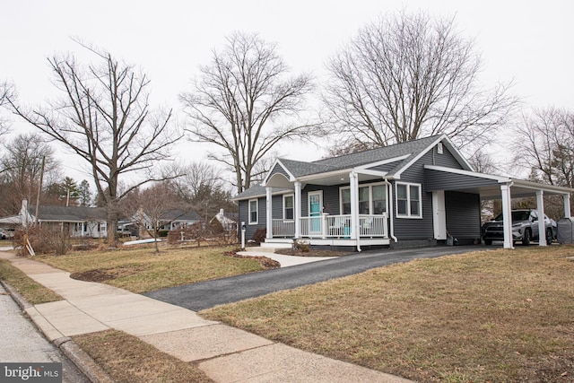 view of front of property featuring a carport, covered porch, and a front lawn