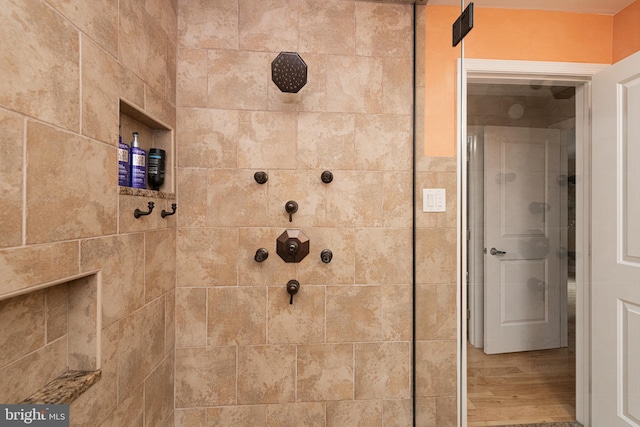 bathroom featuring tiled shower and hardwood / wood-style floors