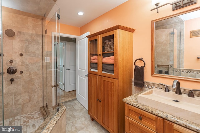 bathroom featuring vanity and an enclosed shower