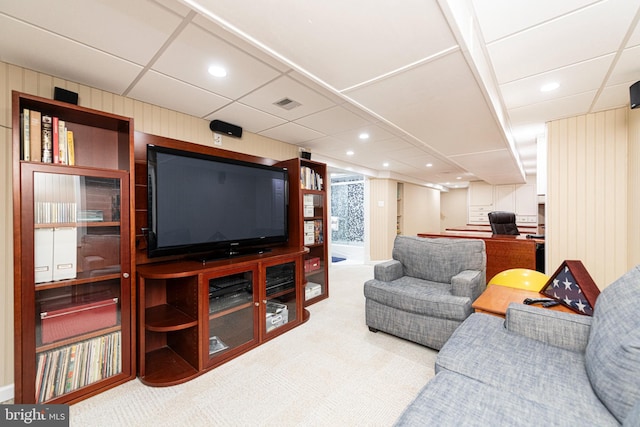 living room with carpet flooring and a drop ceiling