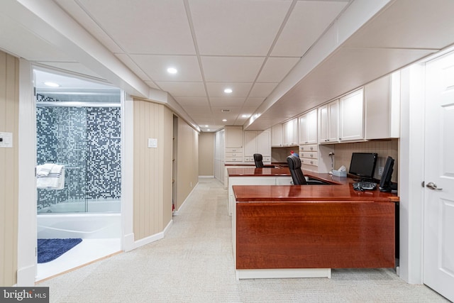 home office featuring built in desk and a drop ceiling