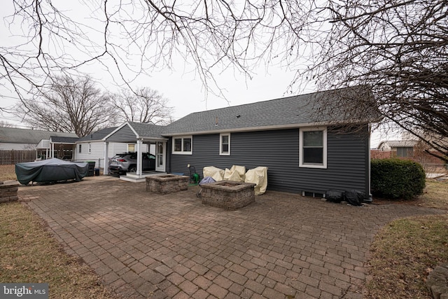 back of house with a patio and an outdoor fire pit