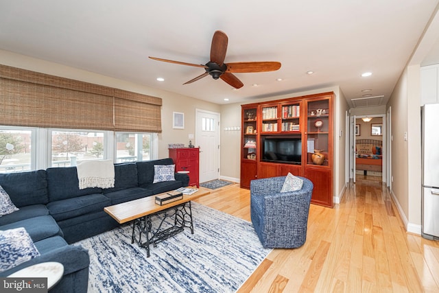 living room with ceiling fan and light hardwood / wood-style floors