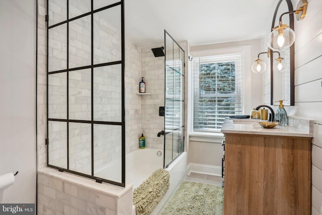 bathroom with vanity and shower / bath combination with glass door