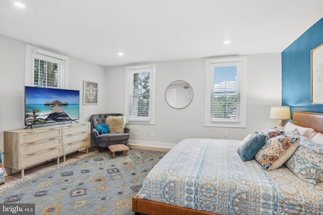 bedroom featuring hardwood / wood-style flooring and multiple windows