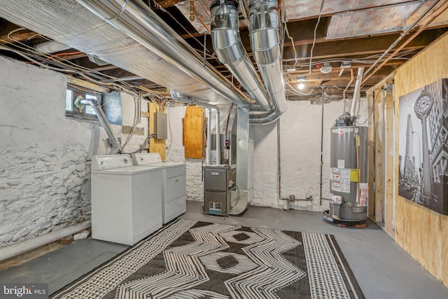 basement featuring electric panel, washer and clothes dryer, heating unit, and gas water heater