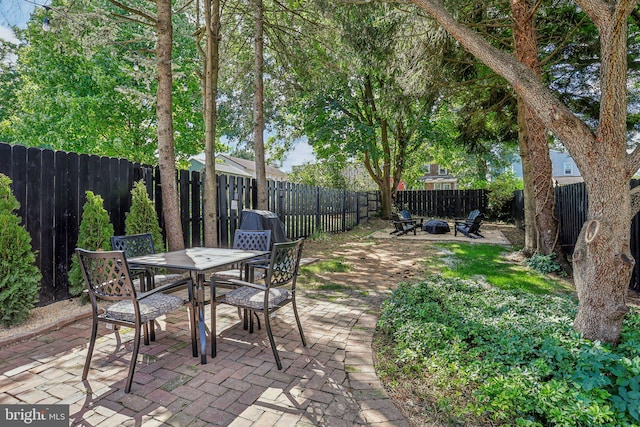 view of patio / terrace with an outdoor fire pit