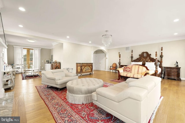 living room with crown molding and light hardwood / wood-style flooring