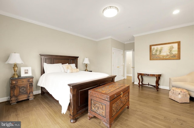 bedroom featuring crown molding and light hardwood / wood-style flooring