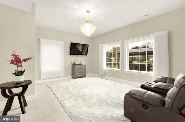 carpeted living room with an inviting chandelier