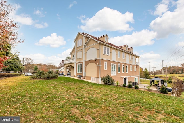 rear view of house featuring central AC, a patio, and a lawn