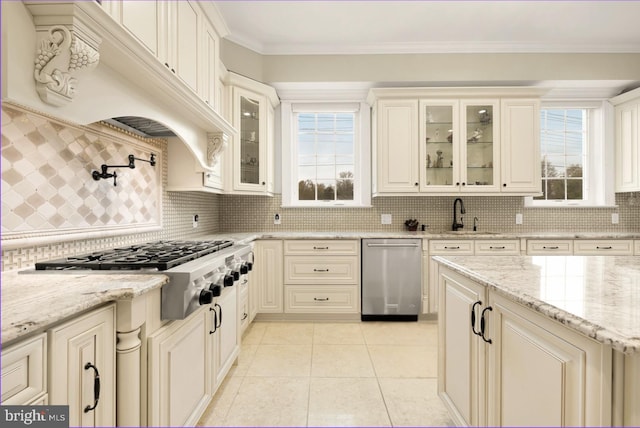 kitchen featuring premium range hood, sink, light stone counters, stainless steel appliances, and crown molding