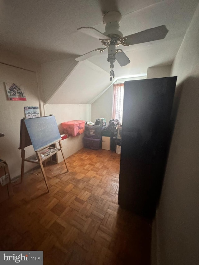 bonus room featuring vaulted ceiling, parquet flooring, and ceiling fan