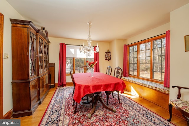 dining space featuring a notable chandelier and light hardwood / wood-style flooring