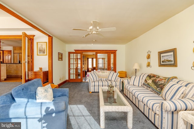 carpeted living room featuring french doors and ceiling fan