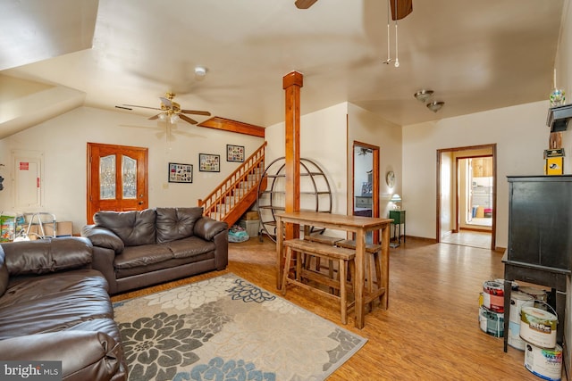 living room with vaulted ceiling, light hardwood / wood-style floors, and ceiling fan