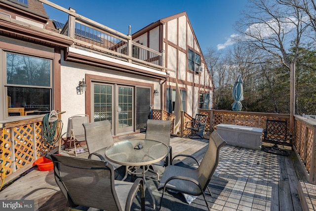 deck featuring a hot tub