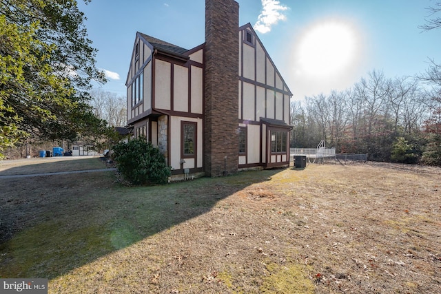 view of home's exterior featuring a yard and central air condition unit