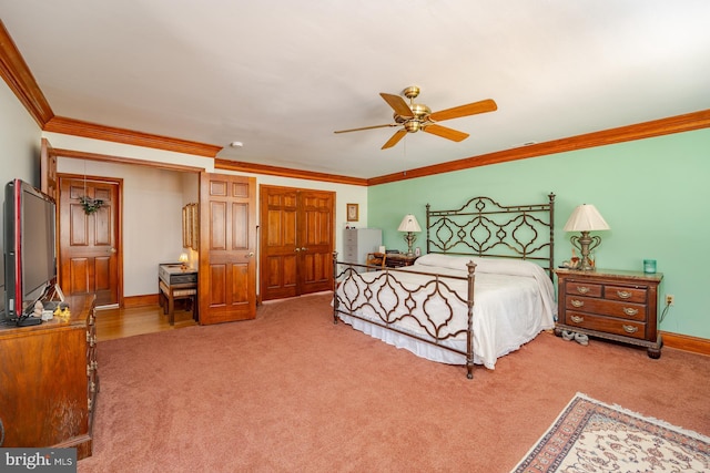 carpeted bedroom with crown molding and ceiling fan