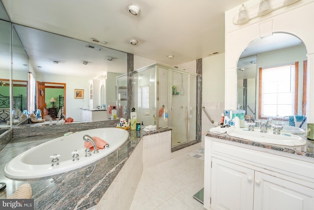 bathroom featuring vanity, plus walk in shower, and tile patterned flooring