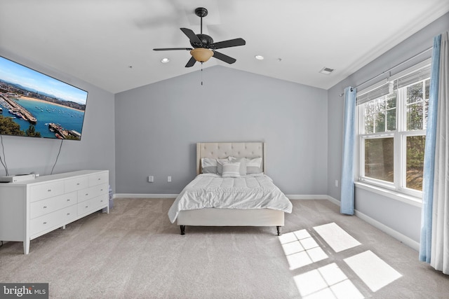 unfurnished bedroom featuring visible vents, light colored carpet, baseboards, and vaulted ceiling