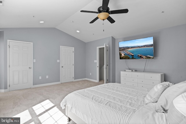 bedroom featuring light carpet, baseboards, and lofted ceiling