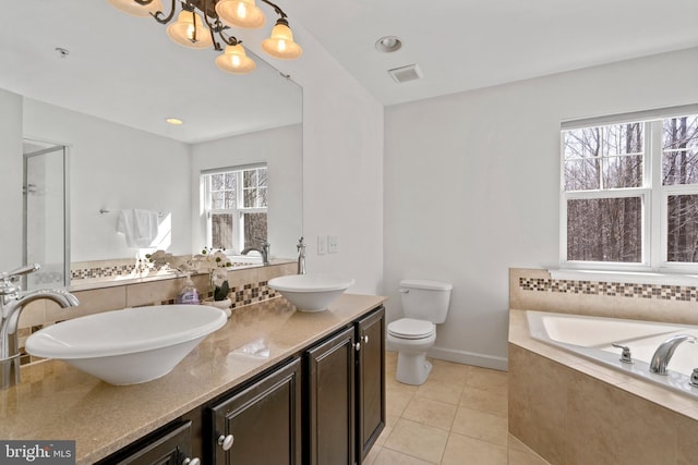 bathroom featuring a sink, backsplash, toilet, and tile patterned floors