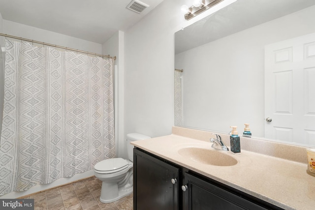 bathroom featuring vanity, curtained shower, toilet, and visible vents