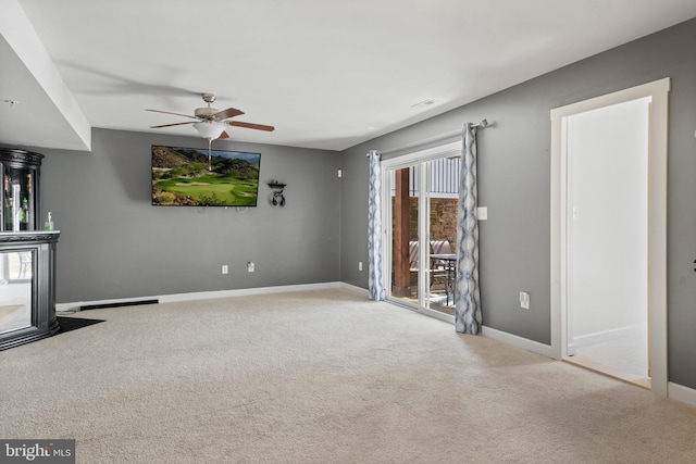 unfurnished living room featuring visible vents, carpet flooring, a ceiling fan, and baseboards