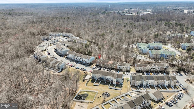 drone / aerial view with a wooded view