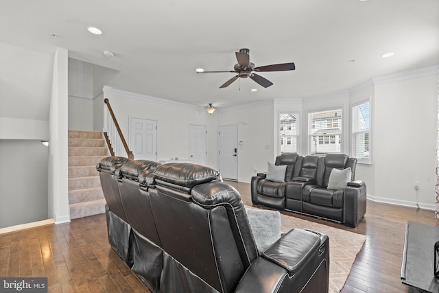 cinema room featuring baseboards, dark wood-style floors, a ceiling fan, and ornamental molding