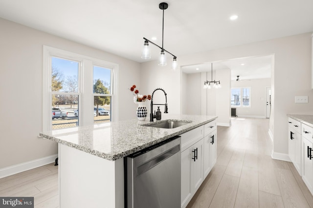 kitchen with sink, white cabinetry, an island with sink, decorative light fixtures, and stainless steel dishwasher