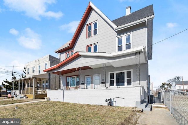 view of front of house featuring a front yard and a porch