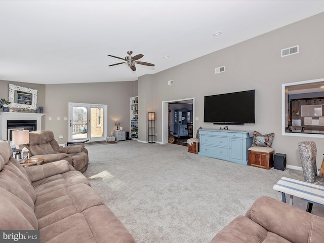 living room with ceiling fan, light colored carpet, and vaulted ceiling