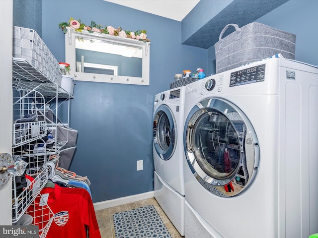 washroom featuring tile patterned floors and washing machine and dryer