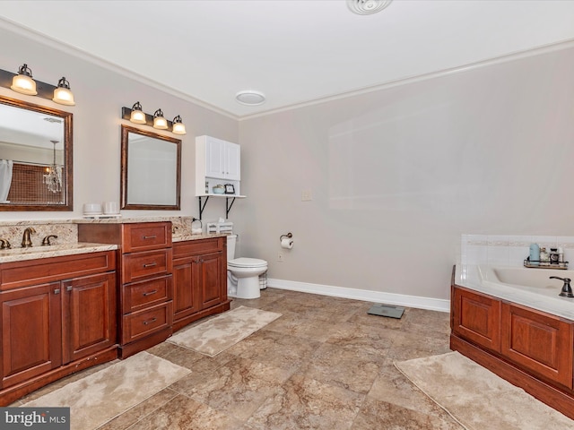 bathroom featuring vanity, a washtub, and toilet