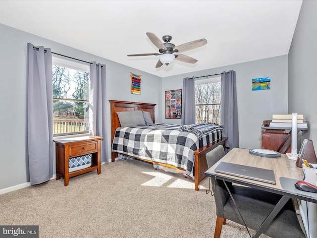 carpeted bedroom with multiple windows and ceiling fan