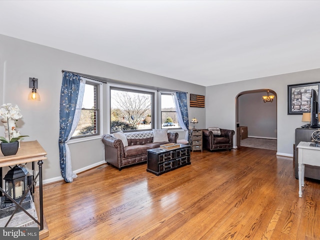 living room featuring hardwood / wood-style flooring and a chandelier