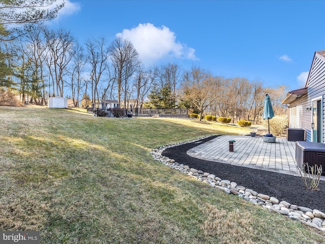 view of yard featuring a storage shed and a patio