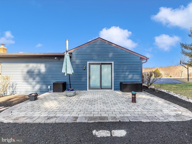 rear view of property featuring a patio area