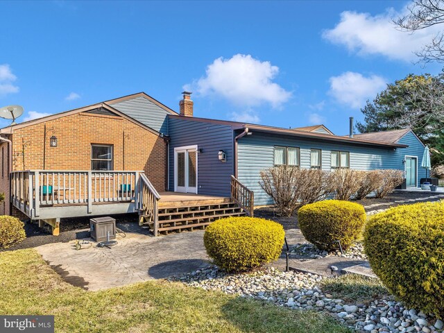 rear view of house with a patio and a deck