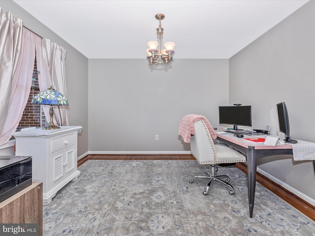 office space featuring an inviting chandelier and hardwood / wood-style floors