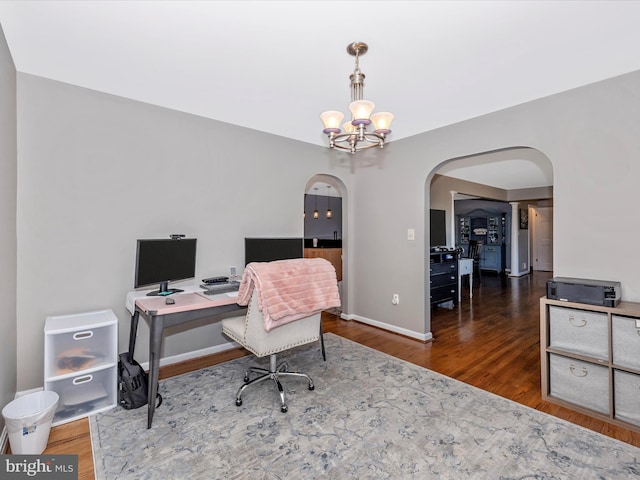 office space featuring a notable chandelier and dark hardwood / wood-style floors