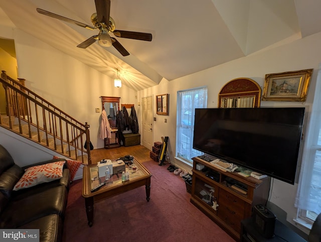 living room with ceiling fan, carpet floors, and vaulted ceiling