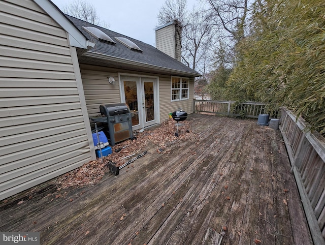 wooden terrace featuring a grill and french doors