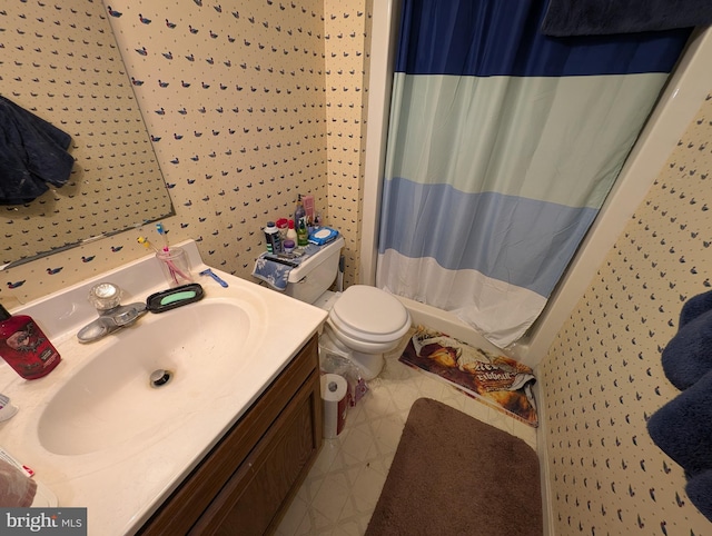 bathroom with toilet, vanity, and walk in shower