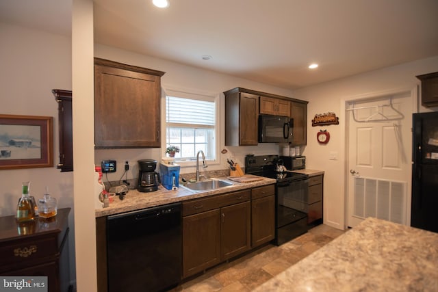 kitchen with visible vents, dark brown cabinets, black appliances, a sink, and recessed lighting